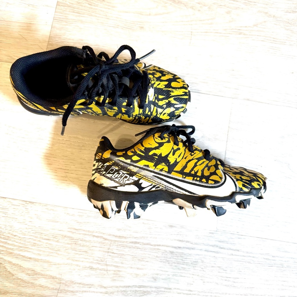 {Nike} gold and black cleats